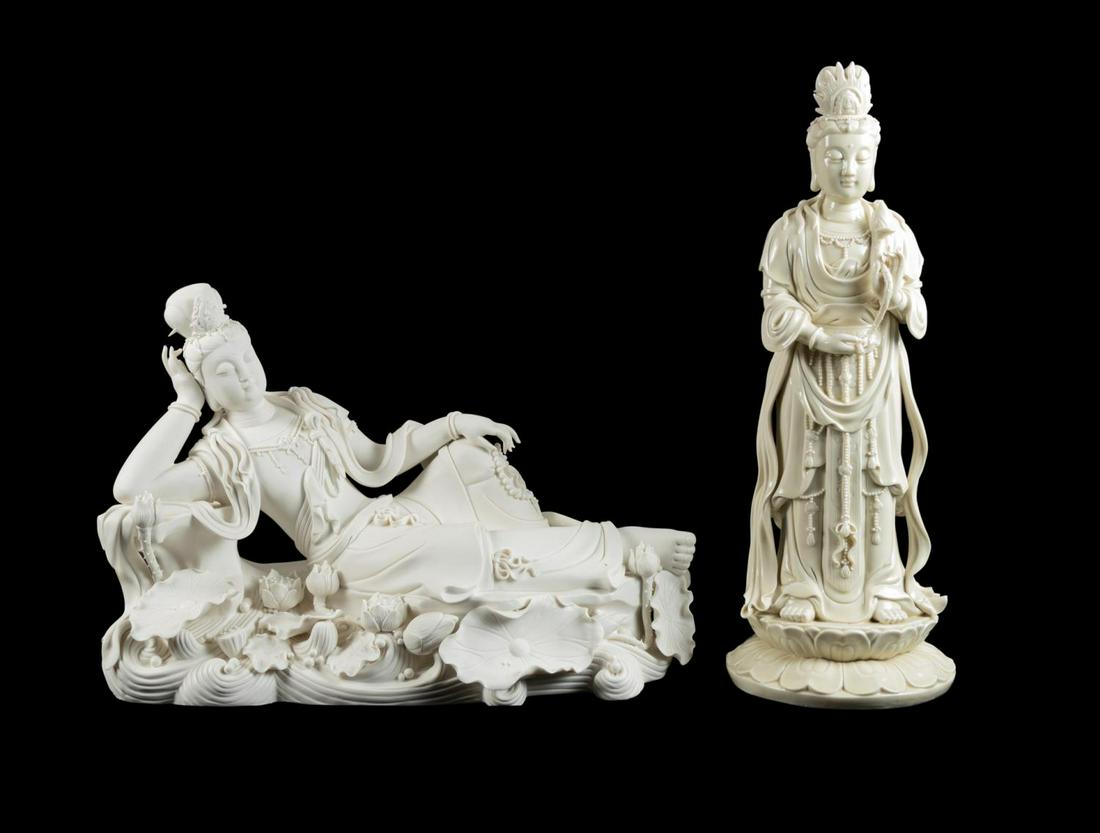 TWO CHINESE BLANC DE CHINE QUANYIN FIGURES: Two Chinese Blanc de Chine Quanyin figures comprising, one standing figure of the Goddess of Mercy in Dehua glazed porcelain, wearing a flaming crown, jewels, and holding a lotus bud, resting on a lot