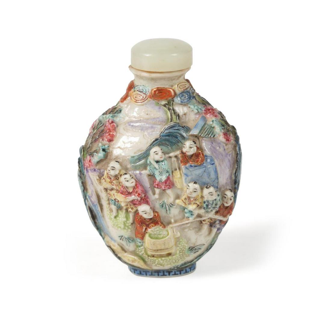 CHINESE FIGURAL FAMILLE ROSE SNUFF BOTTLE: Chinese figural Famille Rose snuff bottle, having a celadon green hard stone stopper, above an ovoid bottle with three-dimensional figures working in a landscape, the underneath with a red Qinglong st