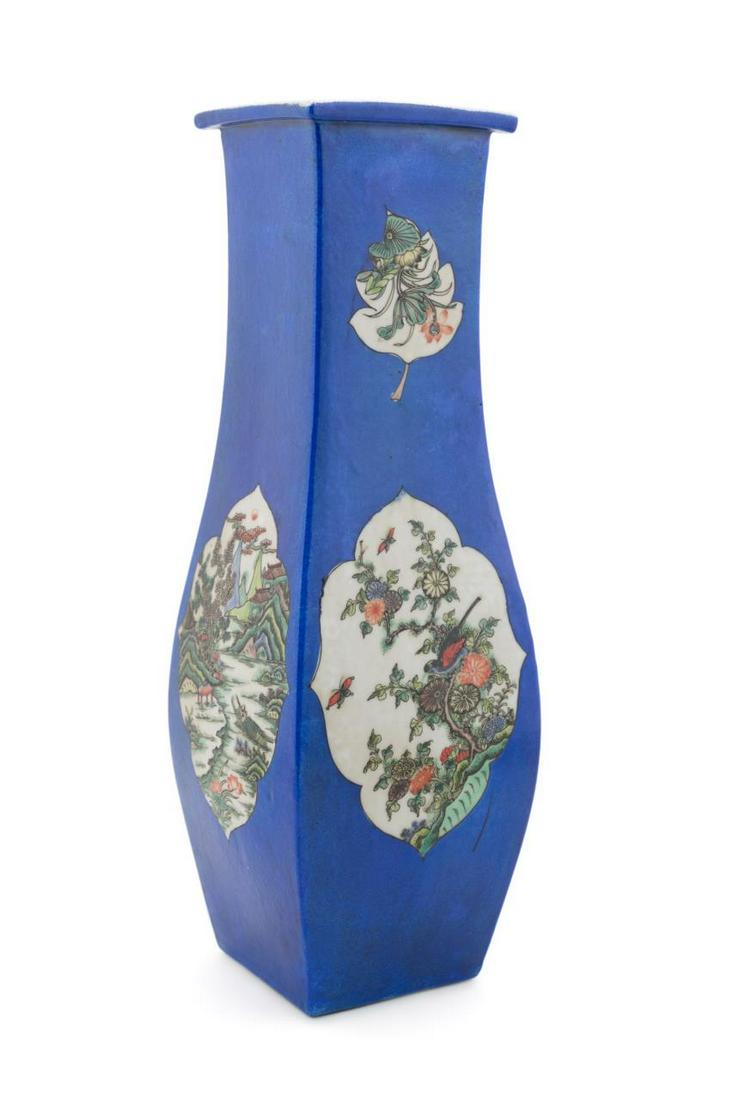 CHINESE BLUE GLAZED FAMILLE VERTE SQUARE VASE: Chinese blue glazed square porcelain vase having a swelled form with alternating reserves decorated with Famille Verte florals, mountainous landscape, and a dragon chasing a flaming pearl, Kangxi type