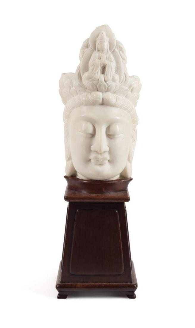 CHINESE MARBLE BUST OF QUAN YIN W/STAND: Chinese carved marble bust of Quan Yin, depicted with up-swept hair wearing a crown centering Buddha seated on a lotus throne, the whole resting on a custom wood stand. Provenance: From the Estate of 