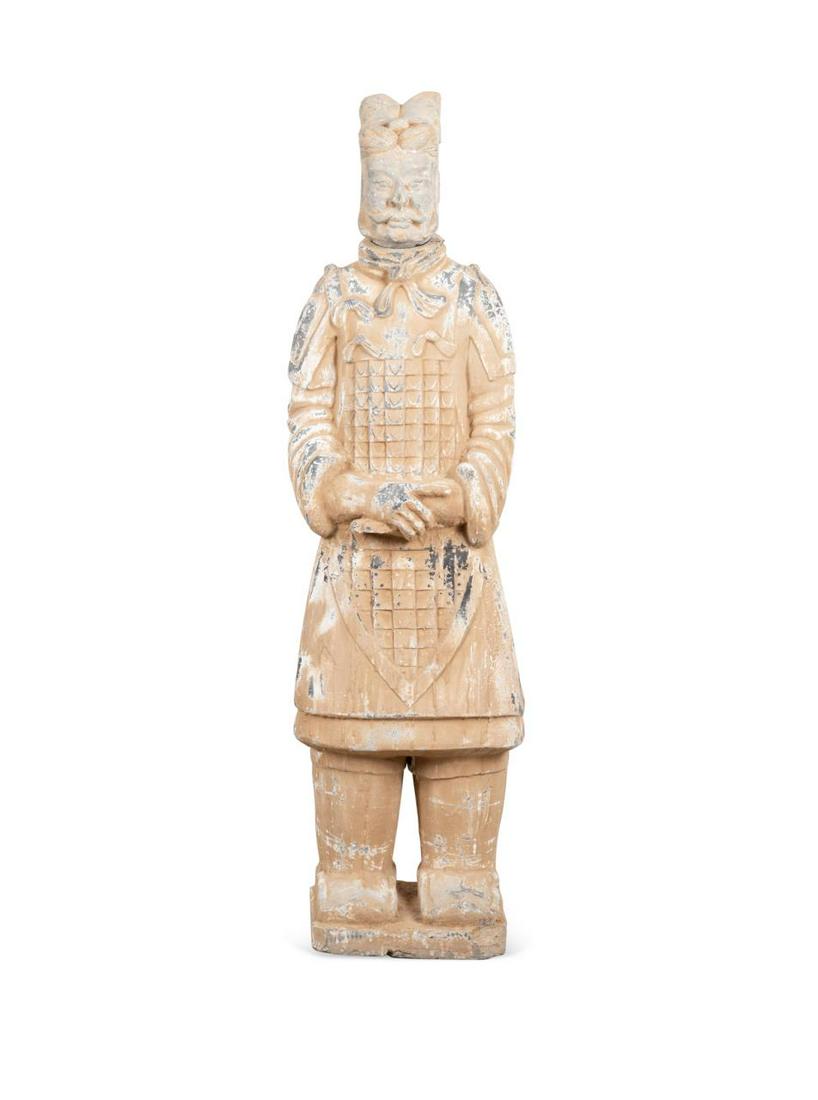 LIFE SIZE CHINESE TERRACOTTA WARRIOR STATUE: Life size Chinese terra cotta warrior replica, the cast stone two-piece standing figure having an elaborate coiffure and moustache on the detachable head, wearing period correct armor and having hands