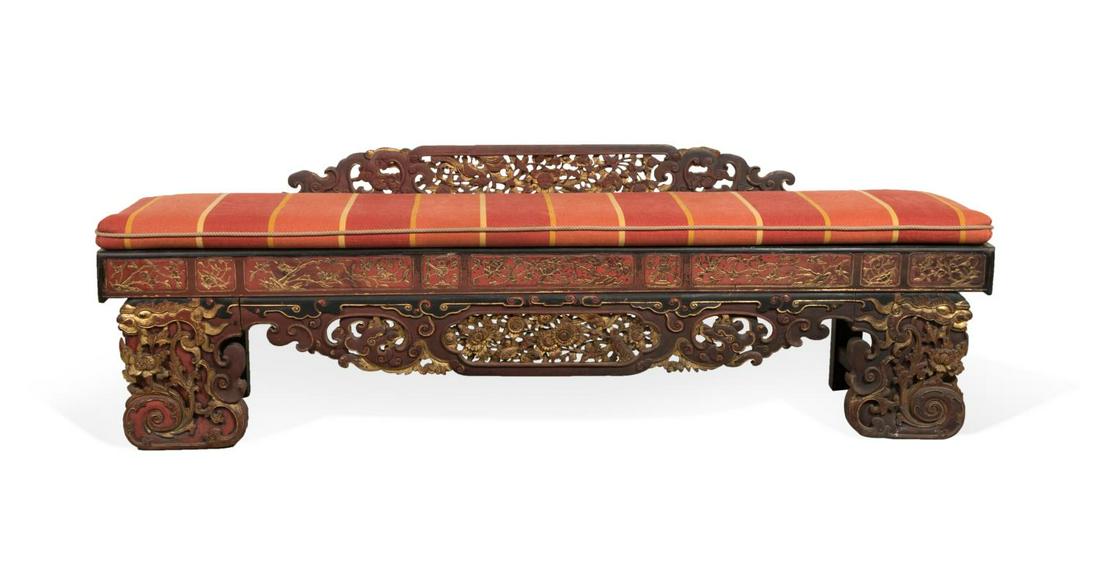 CHINESE RED & BLACK PARCEL GILT DRAGON BENCH: Chinese red and black parcel gilt bench, having a carved and pierced back and apron, loose seat cushion, and rising on front dragon form feet, apparently unmarked. Approximate dimensions: h. 28. 5", w