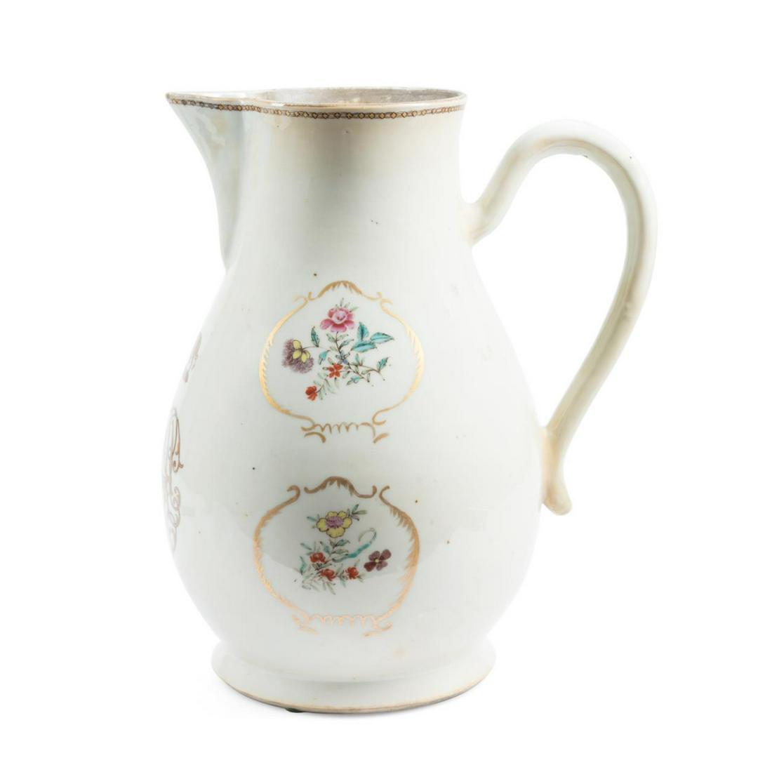 18TH/19TH C. CHINESE EXPORT PORCELAIN PITCHER: Large Chinese Export porcelain Famille Rose pitcher 18th/19th century, having an armorial crest of a boar on a torse or and gule above a cipher, flanked by Rococo shaped reserves decorated with floral