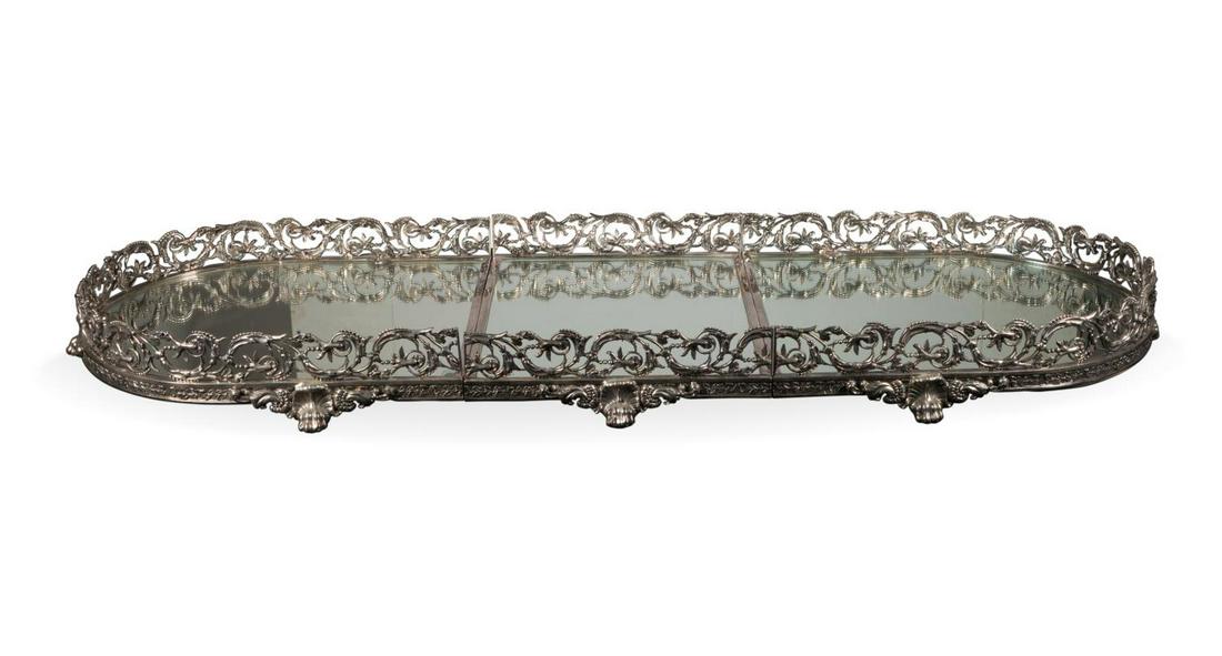 REGENCY STYLE SILVERPLATE MIRRORED PLATEAU: European three-part silverplate plateau or surtout de table in the Regency taste, having a reticulated scrolled foliate rail enclosing mirrored plates, and rising on acanthus paw feet, stamped "1", "2