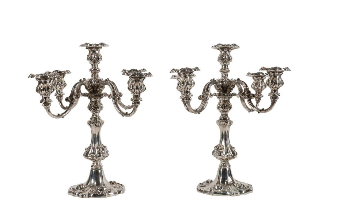 PAIR WALLACE FIVE-LIGHT SILVERPLATE CANDELABRA: Pair of Wallace Silversmiths Inc. (American 1871), five light convertible candelabra in the Neo-Rococo taste, each having a scrolled stem issuing curving arms with swelled sconces and rising on a shap