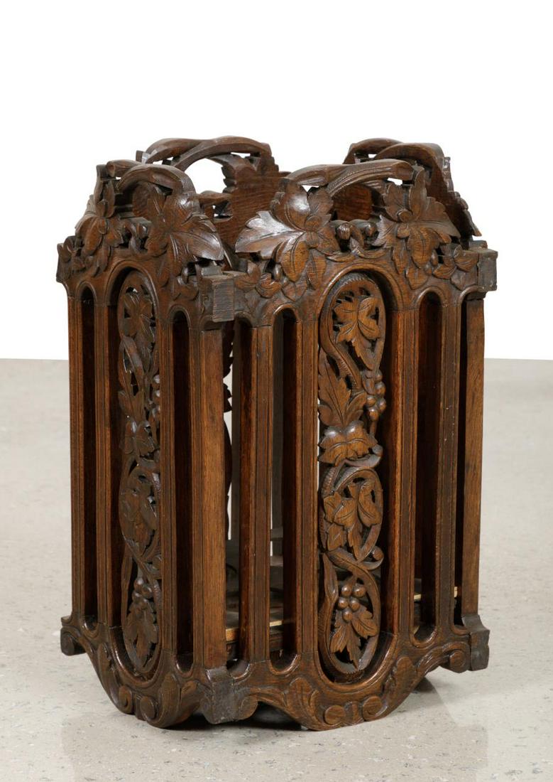 AMERICAN RENAISSANCE REVIVAL OAK UMBRELLA STAND: American Renaissance Revival carved oak umbrella stand, late 19th or early 20th century, having a grape vine and foliate pierced body, apparently unmarked. Approximate dimensions: h. 21. 75", w. 13", 