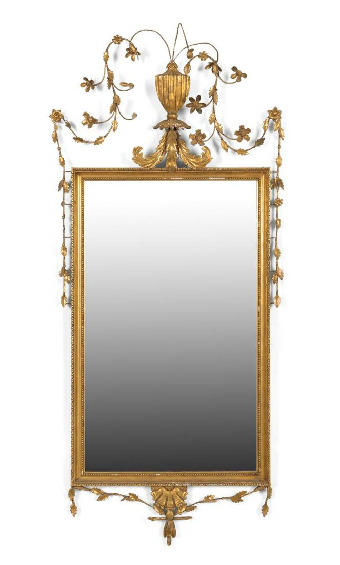 19TH C. NEOCLASSICAL STYLE GILTWOOD & GESSO MIRROR: European giltwood and gesso mirror in the George III Neoclassical taste, 19th century, having an urn form crest issuing garlands of leaves, apparently unmarked. Approximate dimensions: h. 60. 75”, w