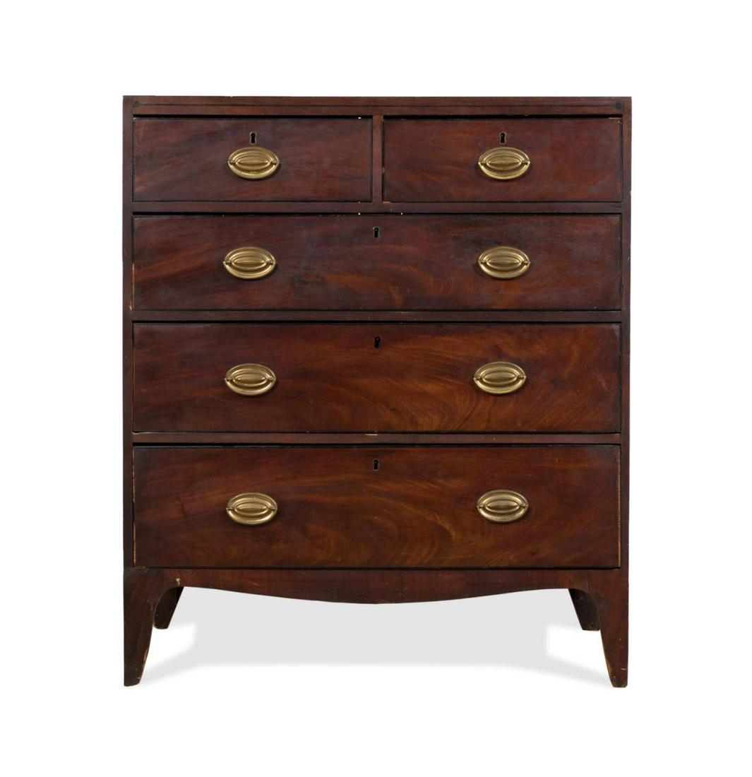 GEORGE III STYLE MAHOGANY CHEST OF DRAWERS: English George III style mahogany five drawer chest, second half 19th century, having a rectangular top, string inlay, brass oval pulls, and rising on French bracket feet, apparently unmarked. Approxi