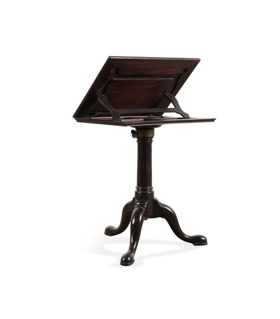 GEORGE III MAHOGANY READING TABLE, C. 1775: English George III mechanical mahogany reading table, circa 1775, having an adjusting book rest, adjustable shaft, and rising on a ringed pedestal with cabriole legs and pad feet, Parc Monceau, Atlant