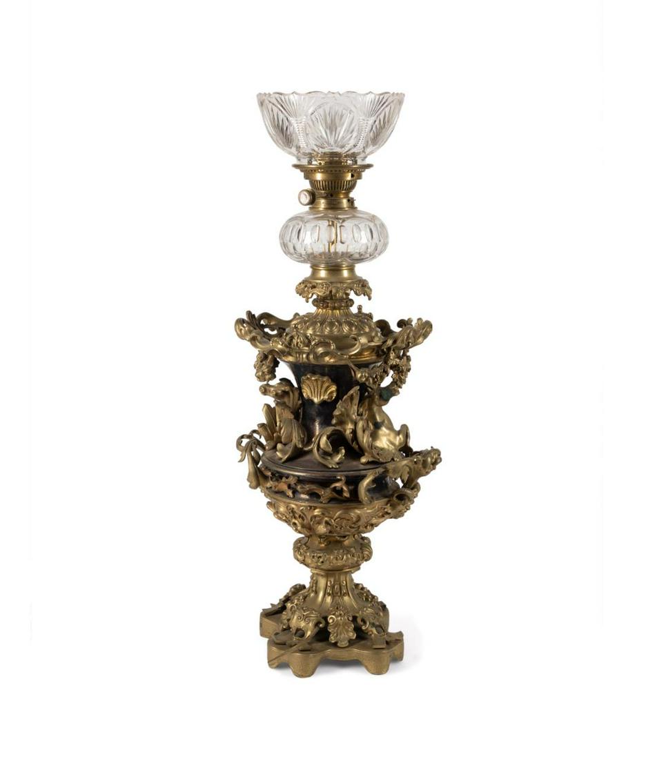 JAMES HINKS & SONS GILT BRONZE FIGURAL OIL LAMP: James Hinks and Sons (English 1858-1925), Victorian gilt bronze oil lamp, second half 19th century, now electrified, having a scalloped colorless anthemion cut glass shade and olive cut bowl, the urn 