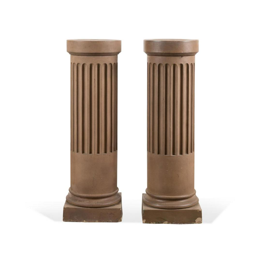 PAIR 19TH C. ENGLISH FAIENCE PEDESTALS: Pair of English taupe glazed faience earthenware column form pedestals, 19th century, each having a circular opening, partial fluted shaft, and rising on a square plinth base, apparently unmarked. App