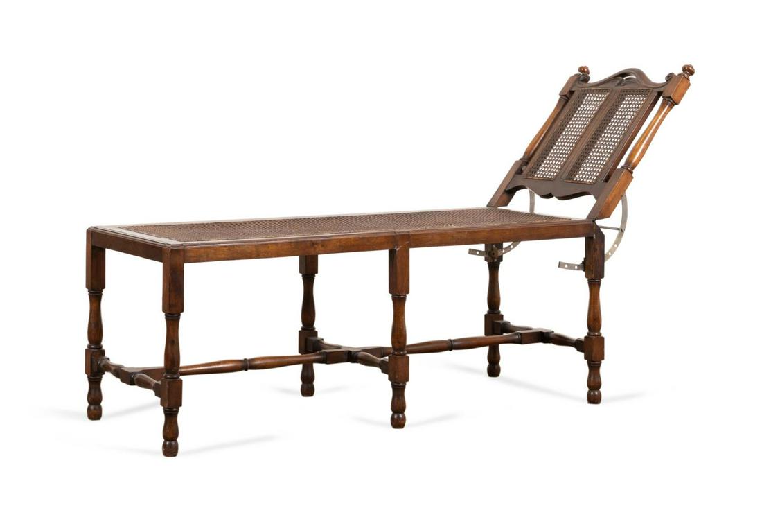 ENGLISH WILLIAM & MARY STYLE CANED WALNUT DAYBED: English adjustable walnut daybed in the William & Mary taste, early 20th century, having caned back and seat panels, curved crest, and rising on turned legs and feet, apparently unmarked. Approximate 