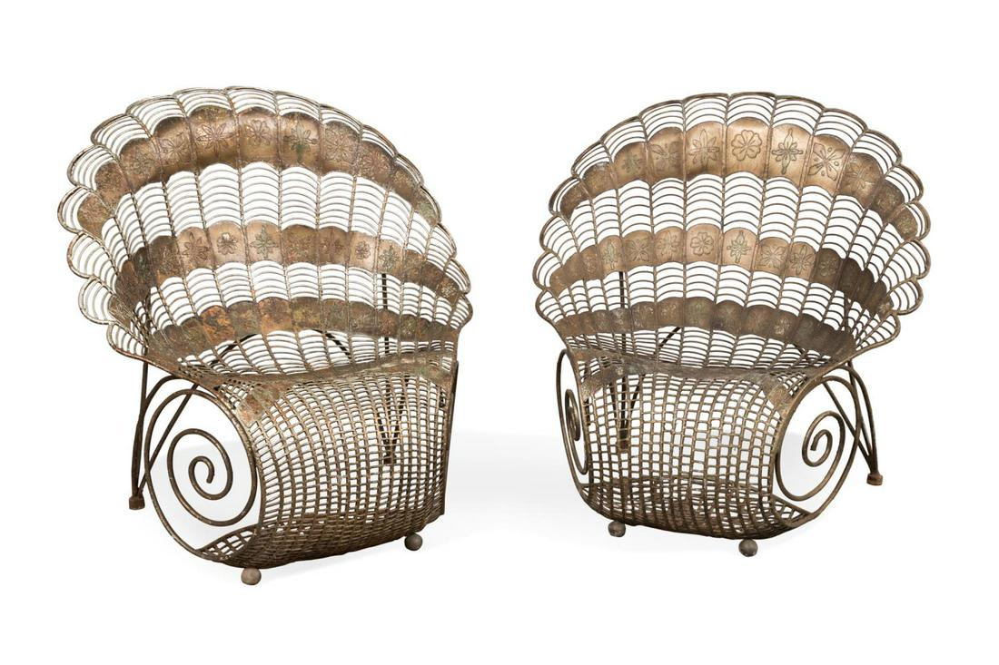 PAIR OF PAINTED MEXICAN IRON PEACOCK CHAIRS: Pair of Mexican painted iron peacock or shell lounge chairs, mid 20th century, each having a plumed tail motif back, floral accents, supported on a scroll form body, and rising on back legs with metal