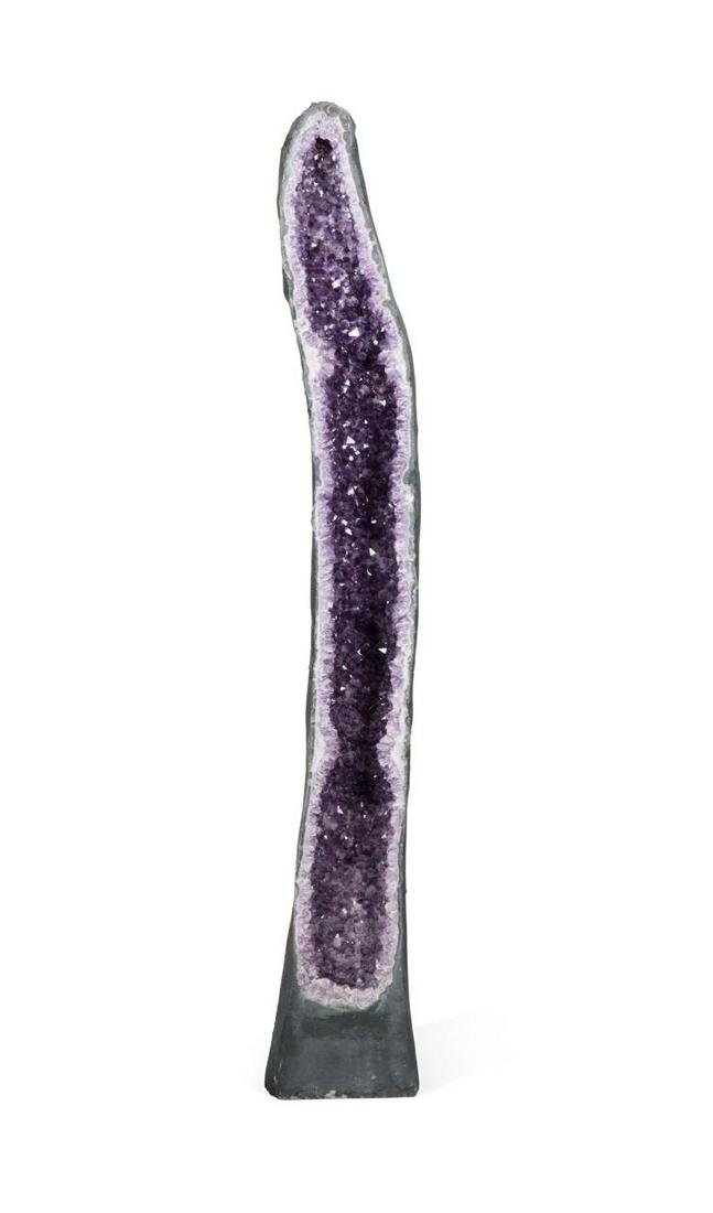 LARGE CATHEDRAL AMETHYST GEODE SPECIMEN: Large amethyst sliced mineral specimen geode having a faceted purple interior, white quartz rim, and dark green exterior. Approximate dimensions: h. 88", w. 13", d. 12".