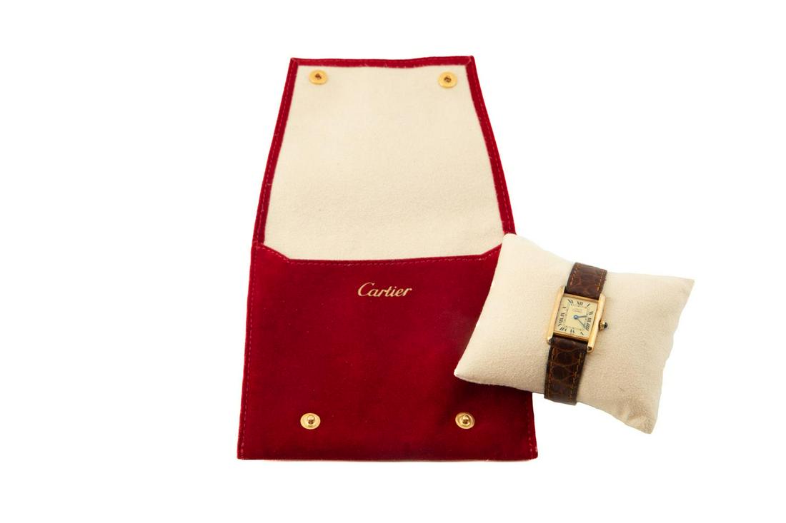MUST DE CARTIER VERMEIL TANK WATCH W/ CARTIER BAG: Must de Cartier vermeil tank watch with Cartier bag, having Roman numerals and a quartz movement, on a brown alligator Cartier strap with gold tone hardware, watch and strap appropriately marked. Appr