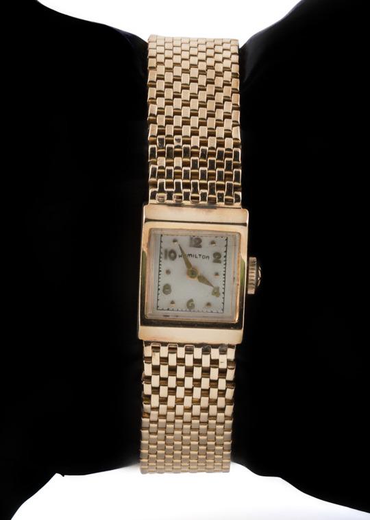 LADIES HAMILTON 14K YELLOW GOLD WRIST WATCH: Ladies Hamilton 14k yellow gold wrist watch, circa 1954, of rectangular form, the enamel dial having applied gold Arabic numerals, with a manual 17 jewel movement and a 14k gold mesh band. Approximate