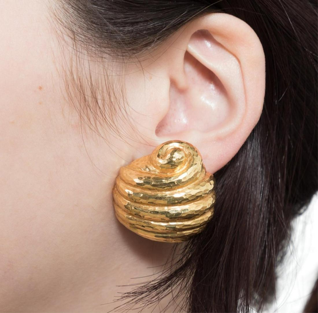 ITALIAN 18K YELLOW GOLD SHELL FORM CLIP EARRINGS: Pair Italian 18k yellow gold shell form clip earrings, of ribbed shell form with a hand applied high polish hammer finish, having omega clip assemblies, marked 750, Italy, weighing 41.6 grams. Approxi