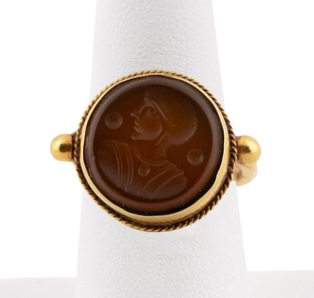20K YELLOW GOLD & CARNELIAN INTAGLIO RING: 20k yellow gold intaglio ring with an engraved brownish red round carnelian tablet featuring a side profile/figural motif. Tested as 20k gold quality. Approximate dimensions: US ring size 7.5, total w