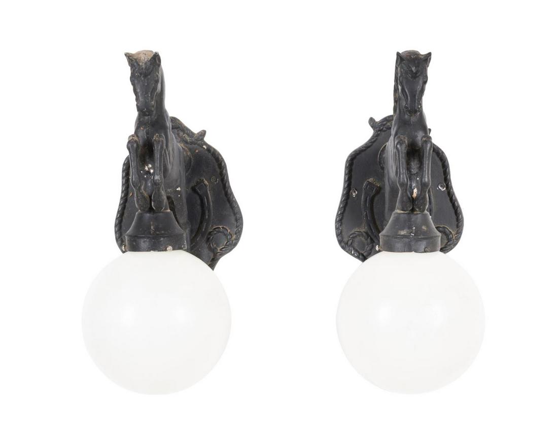 PAIR EQUESTRIAN HORSE FORM METAL WALL LANTERNS: Pair of black painted cast aluminum equestrian motif outdoor wall lanterns in the manner of Tuscumbia Iron Works (American 1962), each modeled as a rearing horse with an opaque plastic globe, apparent