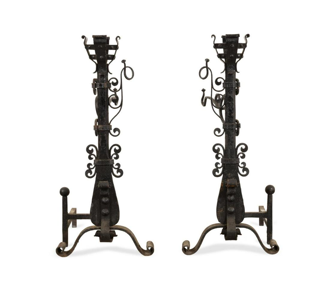 PR LARGE BLACK WROUGHT IRON ANDIRONS, POT HANGERS: Pair of English oversized black painted wrought iron Gothic style andirons, late 19th century, having pot hangers, apparently unmarked. Provenance: From the Collection of Bruce Cusmano, Metropolitan A