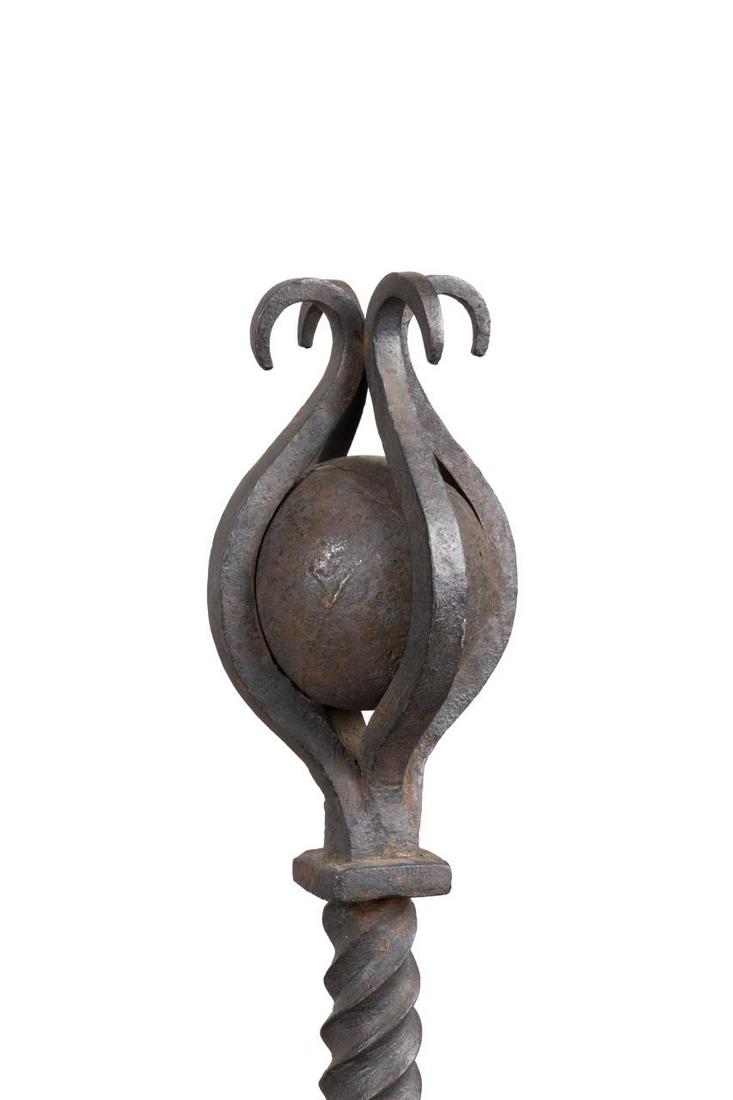 PAIR RENAISSANCE STYLE IRON CROSS BAR ANDIRONS: Pair of Continental wrought iron andirons in the Renaissance taste, 19th/20th century, each having a cage sphere top, twisted stem, corresponding log stop cross bar, and rising on scrolled feet, appar
