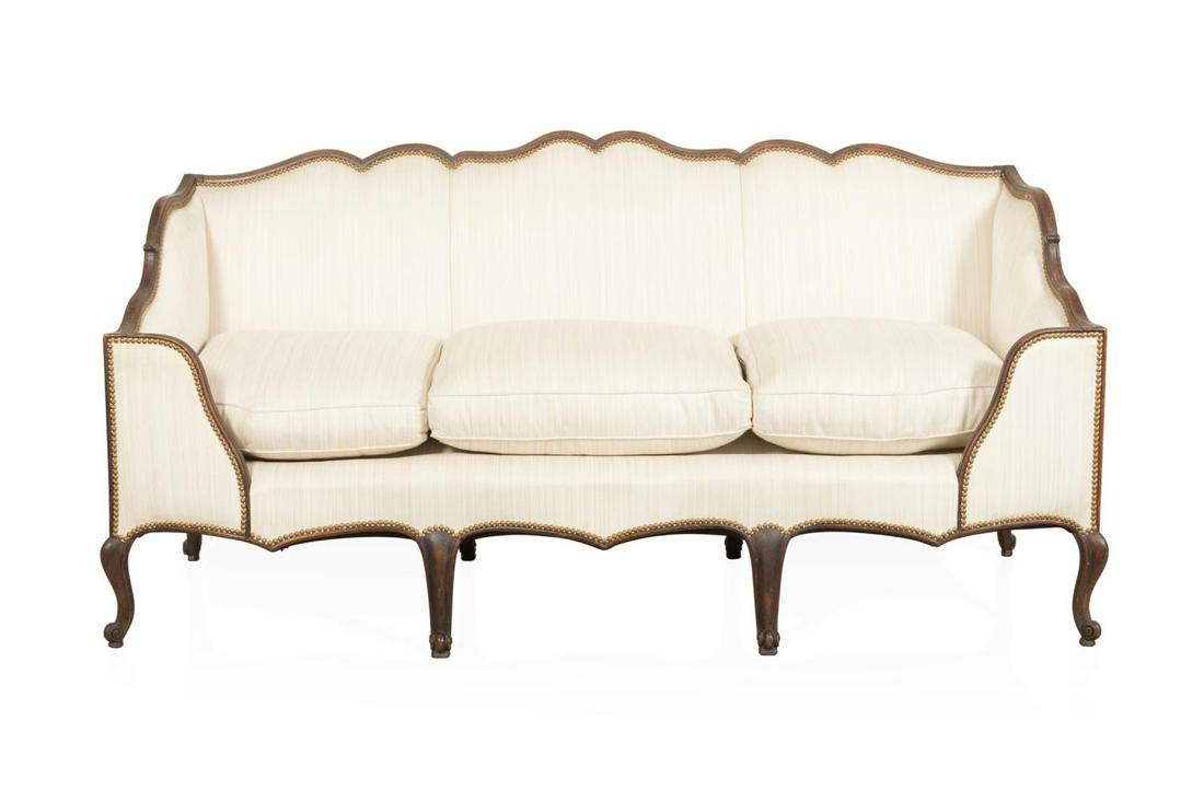 LOUIS XV STYLE WALNUT UPHOLSTERED DAYBED: French walnut day bed or canape in the Louis XV taste, 19th/20th century, having a box form with partial enclosed arms, serpentine crest, three down filled loose seat cushions, and rising on cabriole 