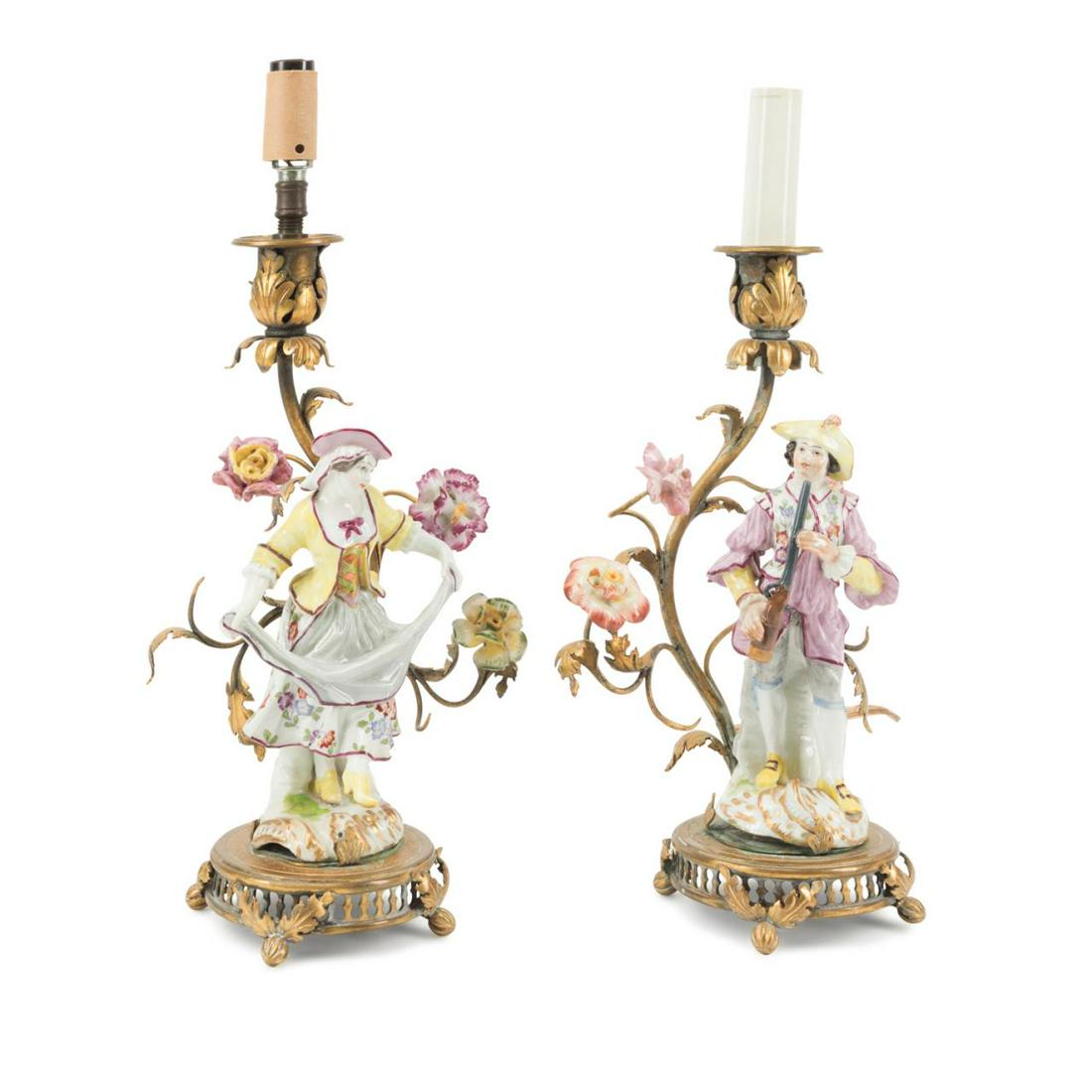 PAIR SAMSON PORCELAIN FIGURES MOUNTED AS LAMPS: Pair of Samson et Cie (French 1845-1969) porcelain figurines, modeled as a hunter and shepherdess, and contained in gilt bronze candlestick lamps with porcelain flowers, crossed blue line marks to the