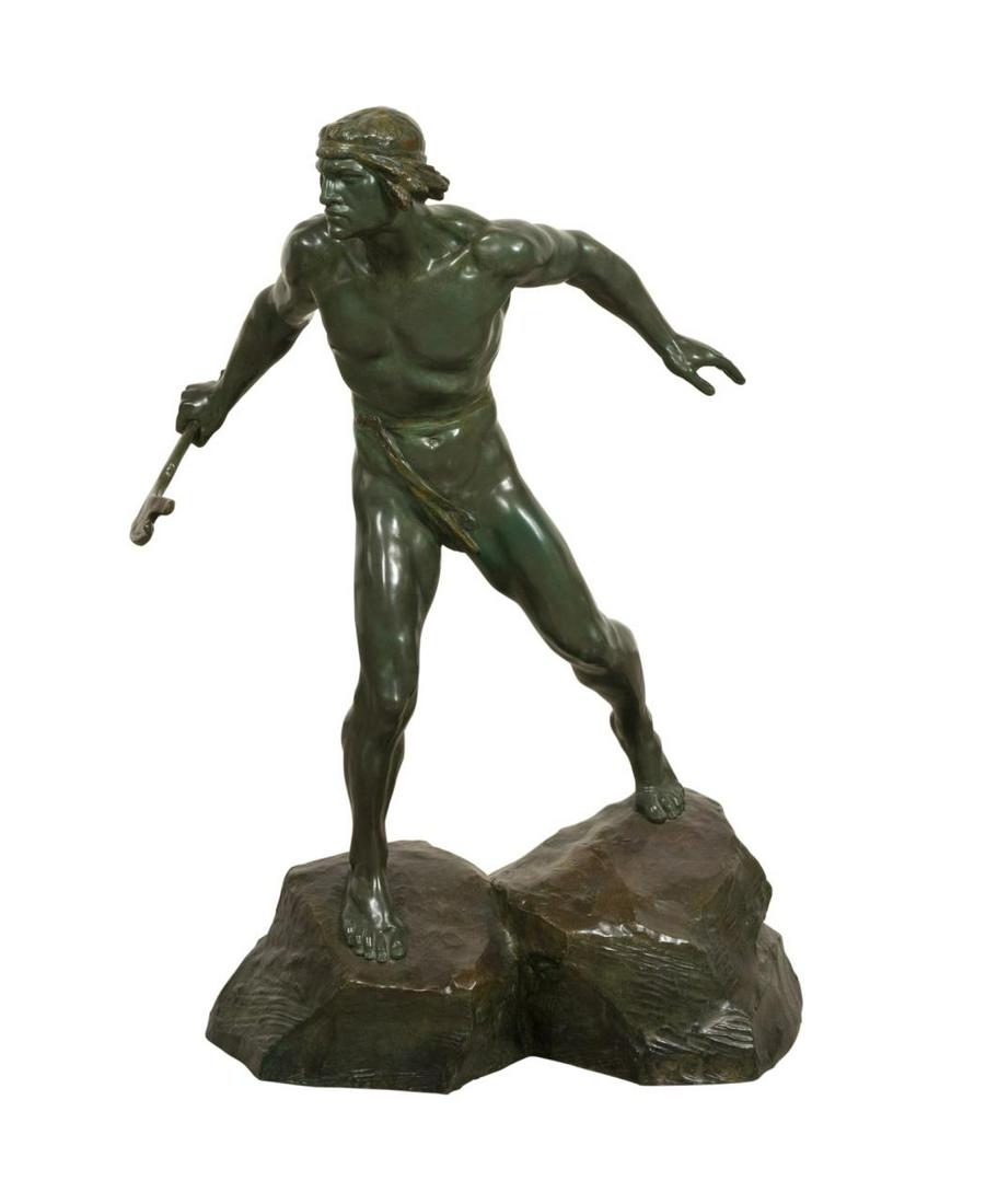 ERNEST CHARLES DIOSI, STANDING WARRIOR, BRONZE: Ernest Charles Diosi (French 1881-1937), untitled, patinated bronze sculpture depicting a male warrior holding a weapon and standing on a rocky outcropping, signed in mold to lower right of base. Appr