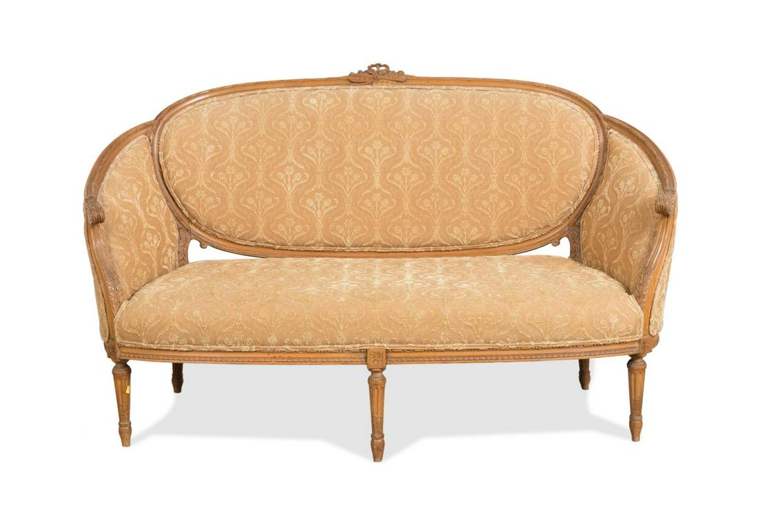 FRENCH LOUIS XVI STYLE CORAL UPHOLSTERED SETTEE: French Louis XVI style light peach upholstered settee, 20th century, having a medallion back with curved upholstered sides, and rising on tapered fluted legs, apparently unmarked. Approximate dimensio