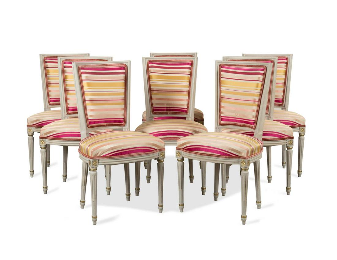SET OF EIGHT LOUIS XVI STYLE PINK STRIPED CHAIRS: Set of eight grey painted and parcel gilt side chairs in the Louis XVI Neoclassical taste, each having a curving square back, horizontal striped upholstery in shades of pink, orange and taupe, and ris