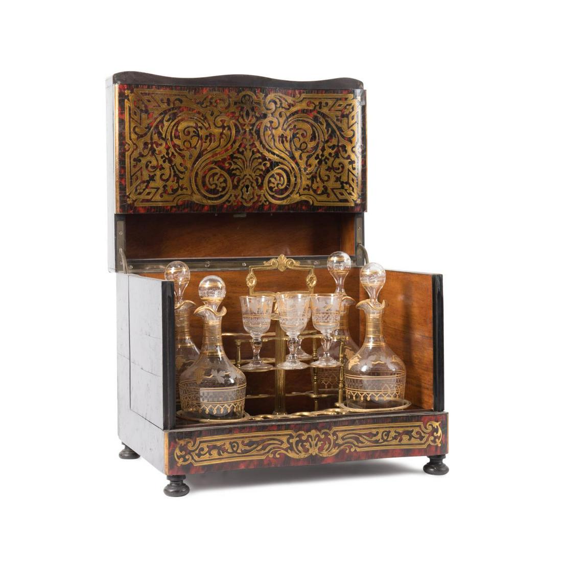 19TH C NAPOLEON III BOULLE EBONIZED CAVE A LIQUEUR: French eight piece Napoleon III boulle shell veneer brass inlaid and ebonized cave a liqueur, 19th century, having a removable tray fitted with gilded bronze mounts, four gilded colorless glass decant