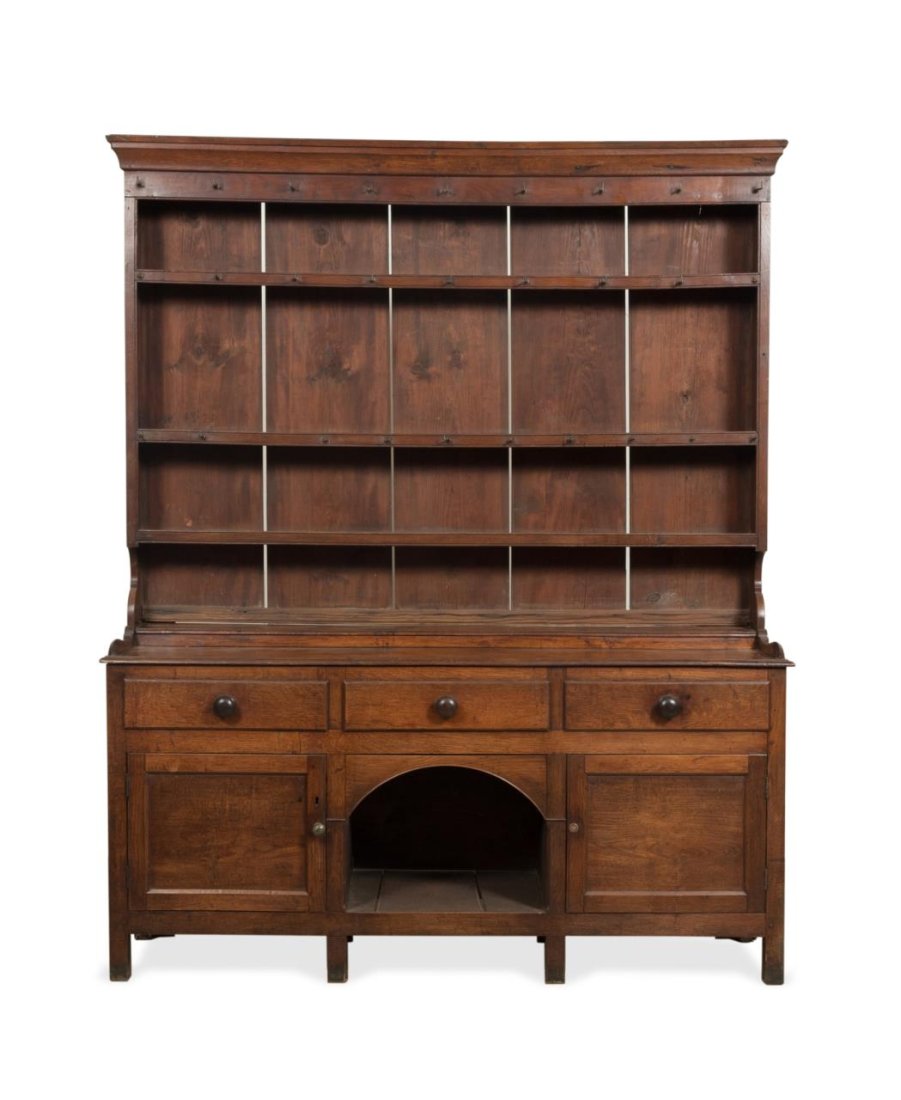 L. 19th C. ENGLISH OAK DRESSER W/ PLATE RACK: English or Welsh oak dresser, late 19th century, having a shaped cornice, plate rack over a three drawer cabinet with a dog kennel shaped opening, and rising on square legs, apparently unmarked. Appro