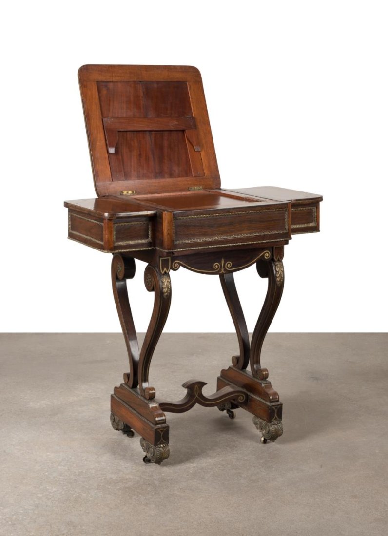 REGENCY BRASS INLAID ROSEWOOD WRITING TABLE: English Regency brass inlaid and mounted rosewood veneer reading or writing and games table, circa 1810, having an adjustable reading/writing surface that slides open to reveal a tooled leather backga