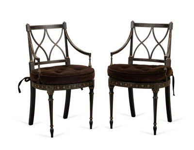 PAIR HICKORY CHAIR BLACK PARCEL GILT ARMCHAIRS: Pair Hickory Chair black parcel gilt wooden armchairs in the Regency taste, each having an X-form splat, caned seat, loose seat cushion, and rising on front tapered legs, Approximate dimensions: h.