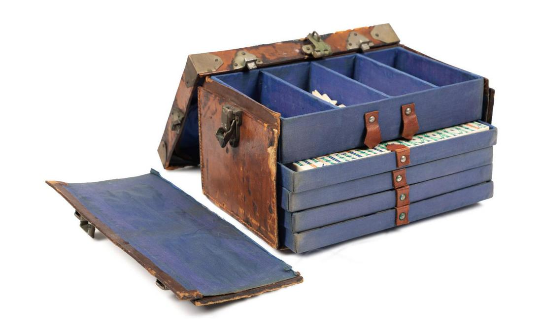 CHINESE MAHJONG SET IN LEATHER COVERED BOX: Chinese mahjong set in a leather cardboard covered box, containing 119 bone counters,144 bone and bamboo tiles, 4 blank tiles hand marked with the letter J (jokers), 5 red chips, 2 green chips, and 2 