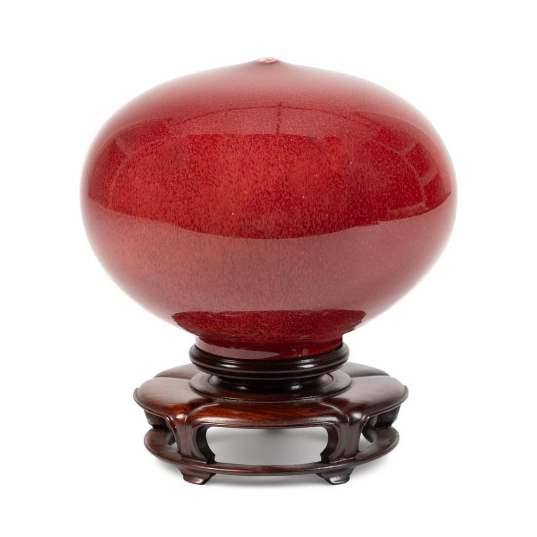 STUDIO SANG DE BOEUF GLAZED MOON POT W/ STAND: Studio pottery moon pot in the style of John Takehara (Korean/American 1929-2009), of globular form with a 4cm opening at the top and allover oxblood glaze, having no apparent mark, resting on a Chine
