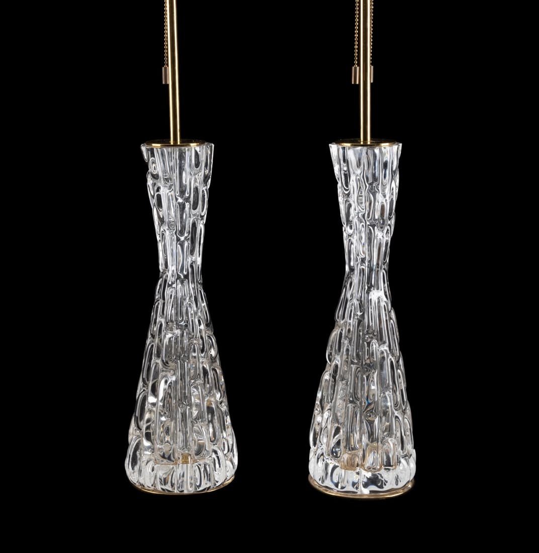 PAIR LG. ORREFORS COLORLESS GLASS AND BRASS LAMPS: Pair of large Carl Fagerlund (Swedish 1915-2011), for Orrefors (Swedish 1898), colorless glass and brass hourglass form lamps, mid-20th century, having molded rectangular patterned bodies, each having