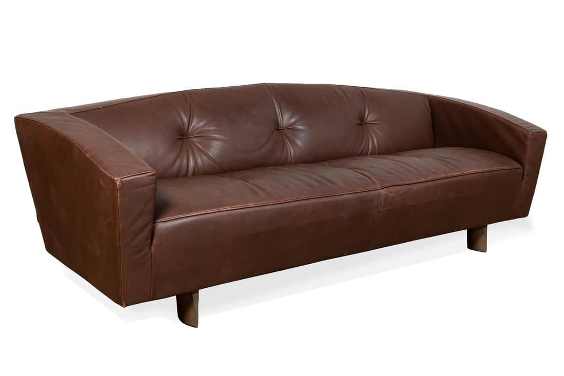 MONTIS MODERN CHOCOLATE BROWN LEATHER SOFA: Montis modernist chocolate leather sofa, the low slung form having a tight back and seat with tufting, rising on lense form bronzed metal feet, marked to the underside of the feet and with a cloth tag