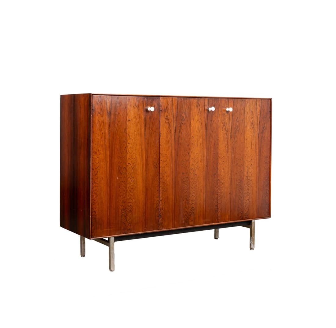 GEORGE NELSON ROSEWOOD GENTLEMAN'S CHEST: George Nelson for Herman Miller (American) Mid Century Modern rosewood and chrome Gentleman's Chest, circa 1958, having three panel doors, a lift top with a mirror and light, and supported on square c