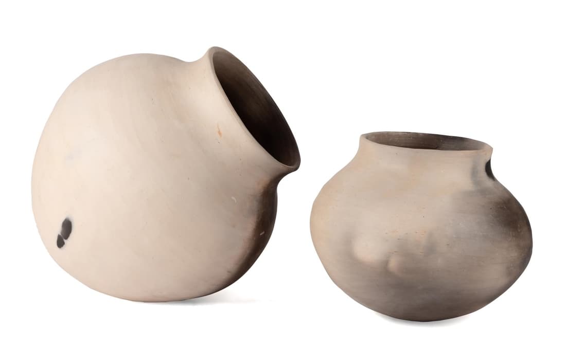 TWO JOEL QUEEN CREAM & BLACK RAKU VESSELS: Two Joel Queen (American/Cherokee b. 1967), cream and black earthenware Raku pottery vessels, the larger having a flared rim and a tapering body in the style of an amphora with no flat surface, the se