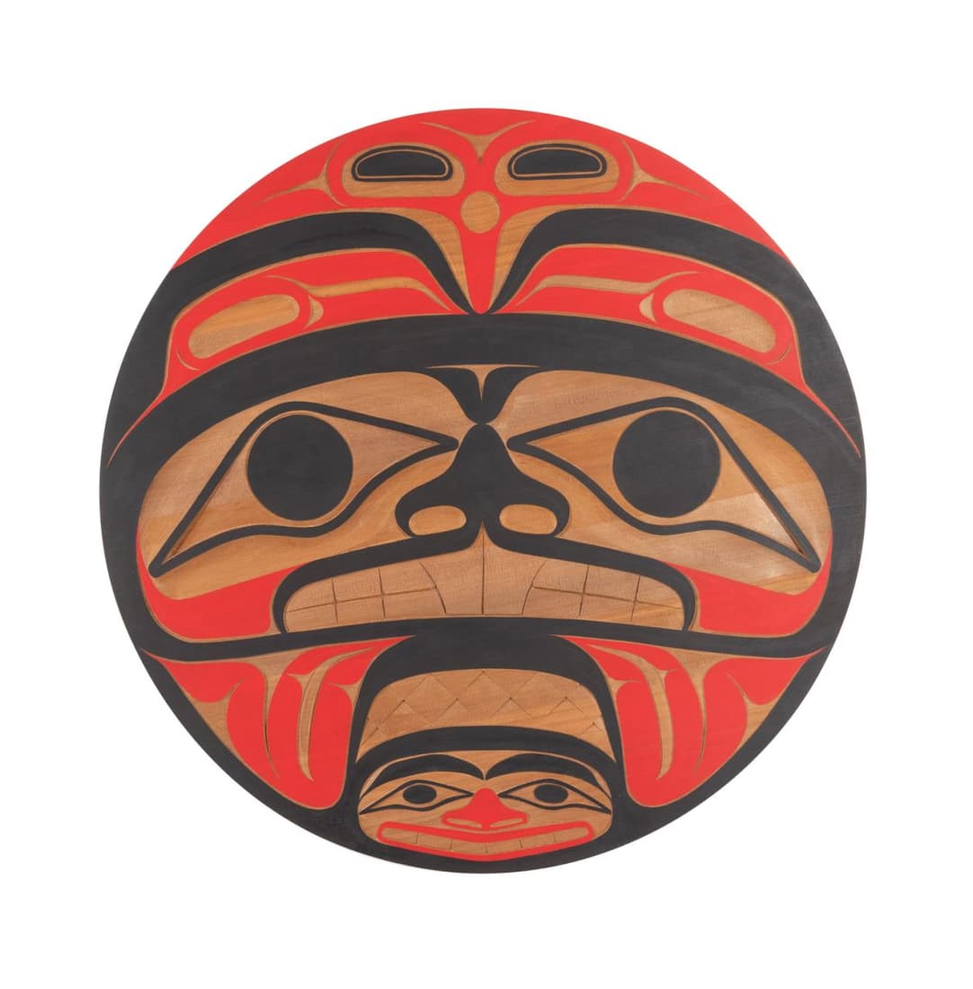 PACIFIC NW COAST ROUND CARVED SPIRIT PANEL: Native American School, Pacific Northwest Coast carved wood circular rendition of three spirits with red and black polychrome paint, initialed to lower left, unframed. Approximate measurements: diam.