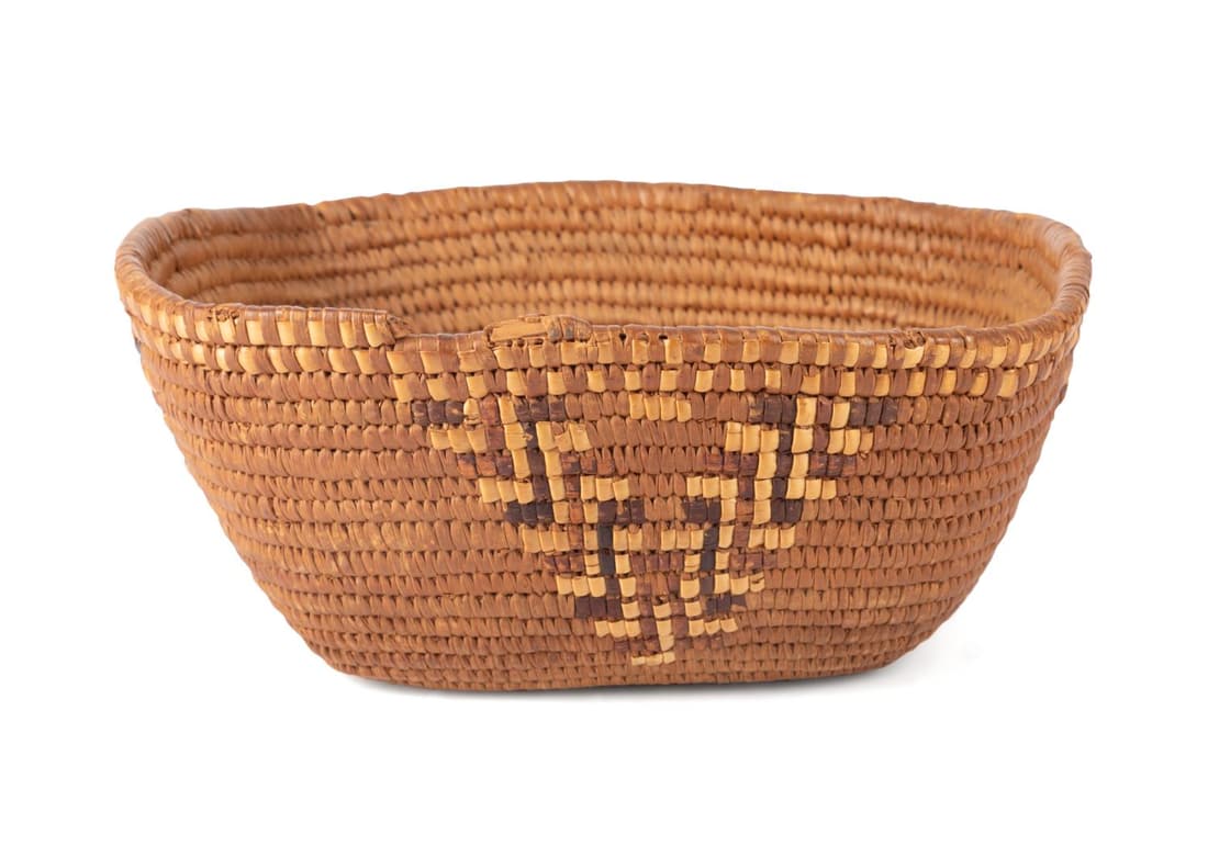 NORTHWEST COAST SALISH PEOPLES BASKET: Northwest Coast Salish peoples basket, in cedar, grasses, spruce root, and cherry bark, of gently curved rectangular form, having a checkerboard at the wrapped rim and multicolor triangular motifs cre
