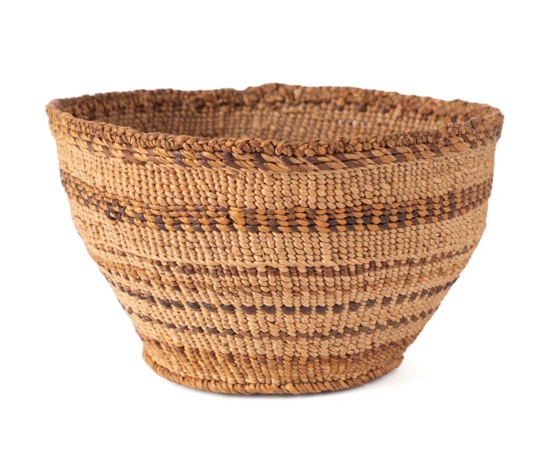 KLAMATH PEOPLES TWINED POLYCHROME BASKET: Klamath peoples twined polychrome basket, circa 1880, likely twined with hazel, cottontail, rush, colored grasses, and poisonwood oak, of tapering form with eight to nine horizontal colored bands, ter