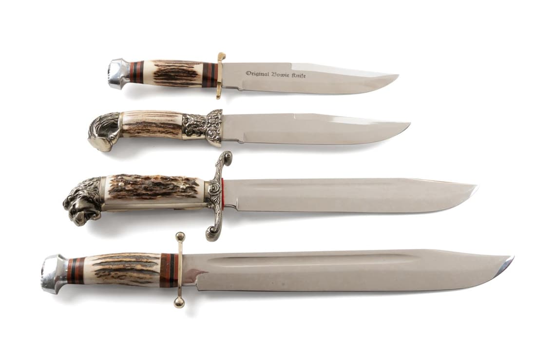 FOUR LARGE STAG HANDLE LINDER-MESSER KNIVES: Four Linder-Messer large, heavy bladed stag handled hunting or display knives, comprising a lion head bowie, an eagle head bowie, and two bowies, one having a brass guard. Approximate measurements: Li