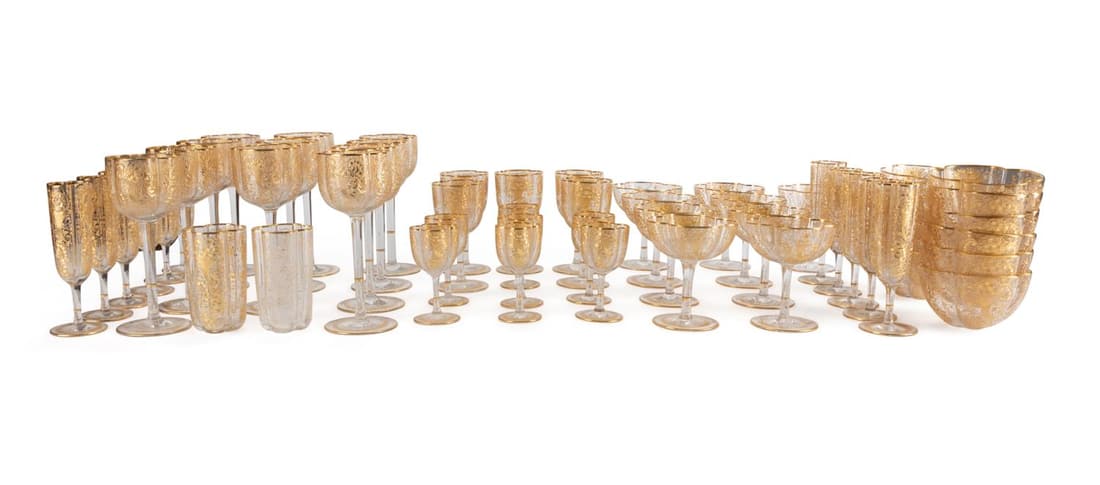 57PC MOSER GILT GLASS STEMWARE & TABLEWARE: 57 piece set of Bohemian Moser (Czechoslovakian 1857) gilt enameled quatrefoil form colorless glass stemware and tableware, late 19th to early 20th century, having scrolled cornucopia decoration compr