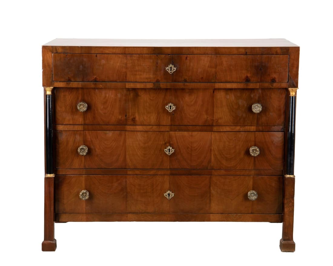 19TH C. BIEDERMEIER WALNUT SECRETAIRE COMMODE: Continental Biedermeier walnut veneer secretaire commode, 19th century, with an overhanging fitted fall front desk supported by parcel gilt ebonized columns flanking three drawers, and rising on squar