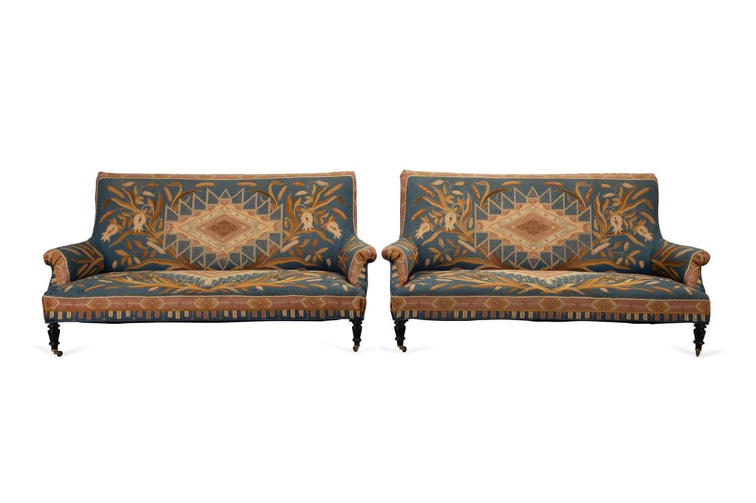 PAIR 19TH C. AESTHETIC MOVEMENT NEEDLEWORK SETTEES: Pair of European, possibly French Napoleon III settees, 19th century, with Aesthetic Movement cattail or bulrush needlework upholstery, and rising on front turned ebonized legs, having no apparent mar