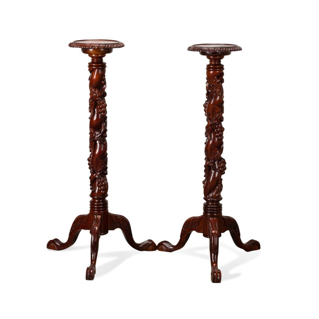 PAIR CHIPPENDALE STYLE CARVED MAHOGANY PEDESTALS: Pair of carved mahogany pedestals in the Chippendale taste, with grapevine decoration and rising on cabriole legs, having no apparent marks. Provenance: : From the Private Collection of William R. Col