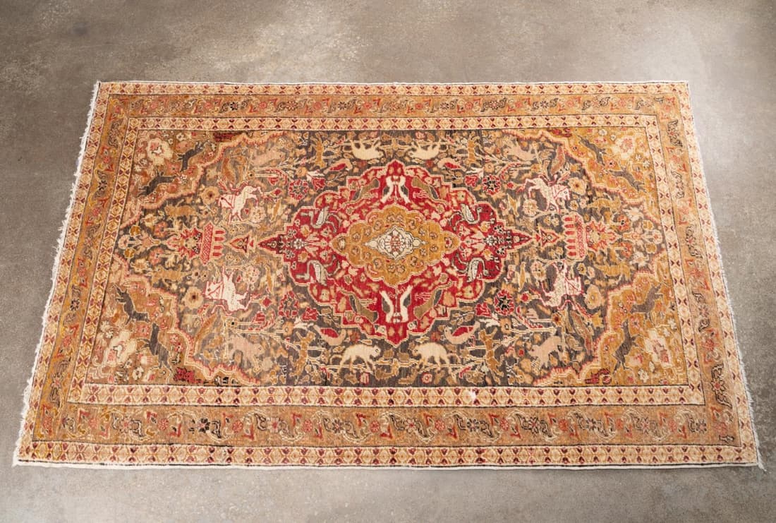 INDO TABRIZ HAND KNOTTED WOOL HUNT CARPET, 7 x 5: Indo Tabriz hand knotted wool hunt carpet, centering an ocher medallion within a crimson medallion with pendants, on a grey ground filled with animals including tigers and monkeys, having ocher spandr
