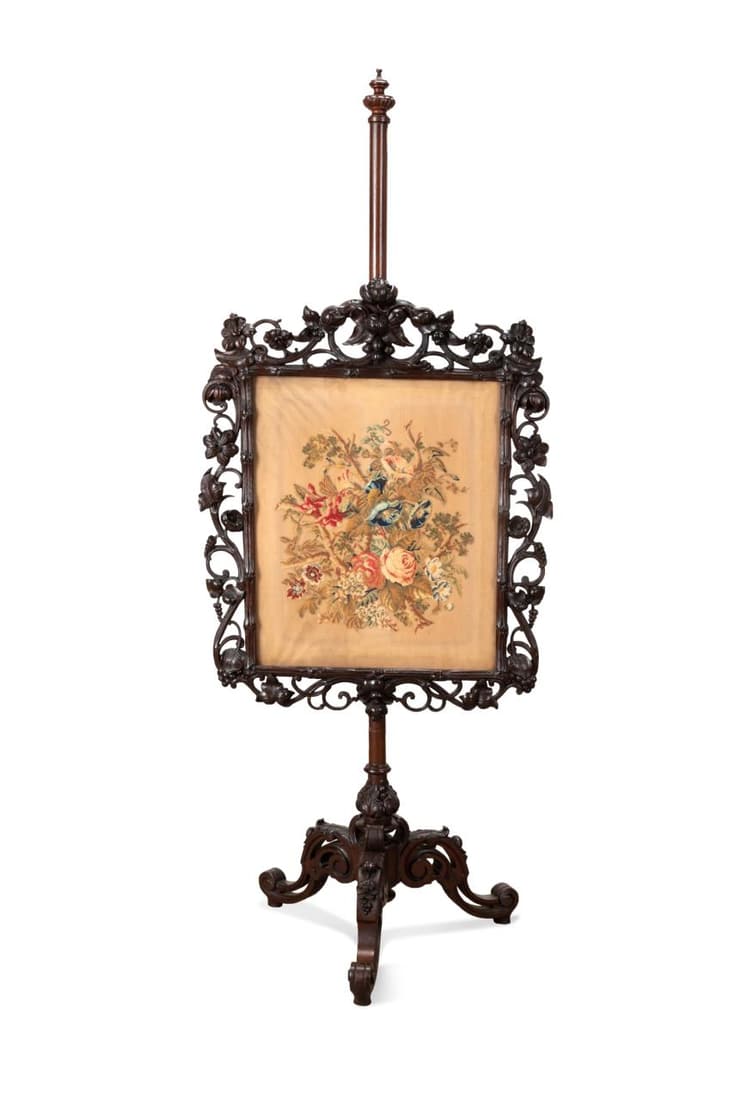 19TH C. RENAISSANCE REVIVAL FIREPLACE POLE SCREEN: English Renaissance Revival mahogany fireplace pole screen, 19th century, with an adjustable floral needlework panel, foliate and grapevine carving, and rising on cabriole legs, having no apparent mar